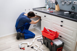 Plumber In Overall Fixing Sink Pipe